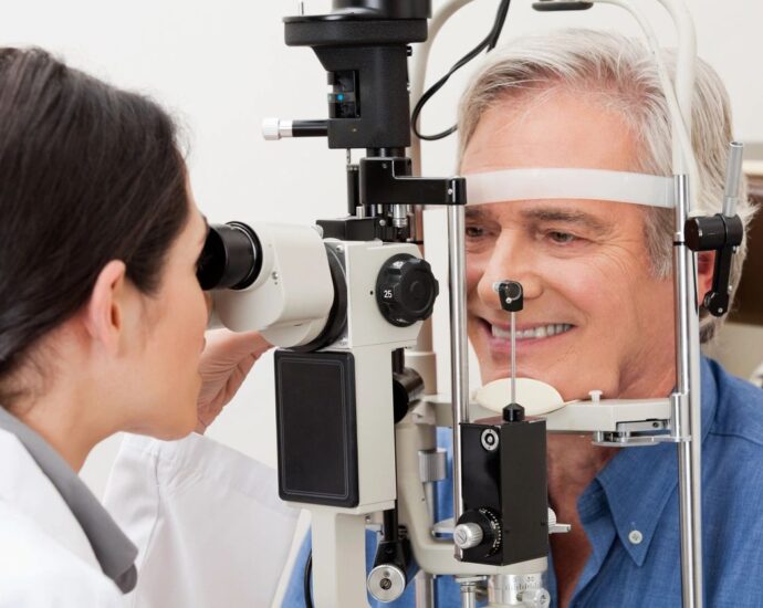 Man getting his eyes examined by eye doctor