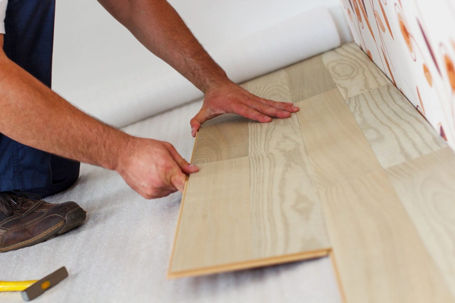 hands installing wood flooring