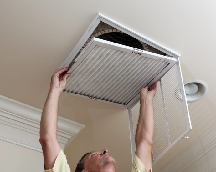 Man changing filter for air conditioner
