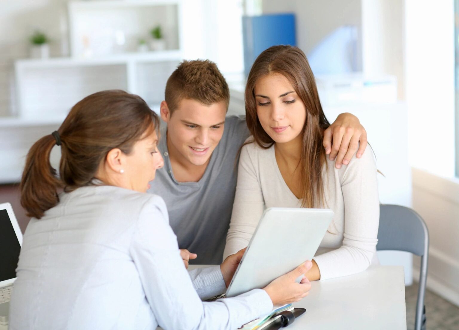 Insurance agent showing a young couple a document