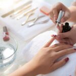 woman's hand receiving manicure