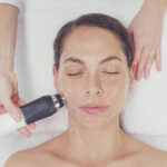 Woman receiving face treatment