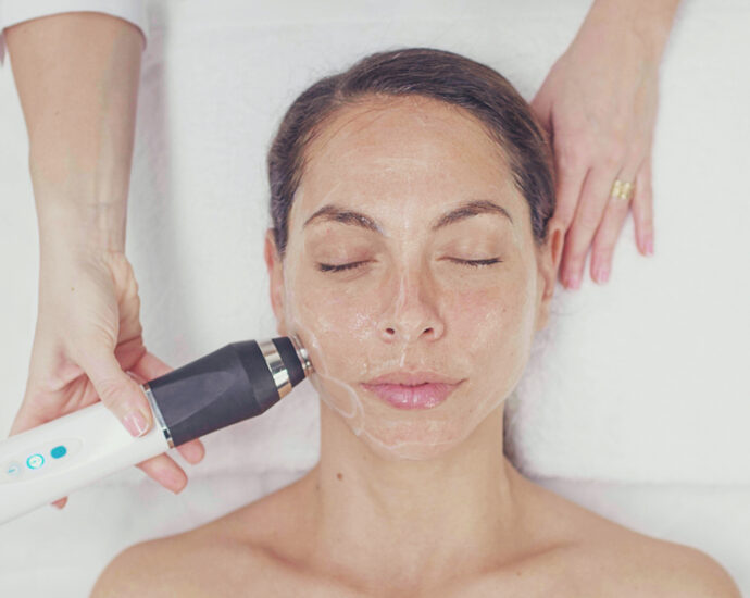 Woman receiving face treatment